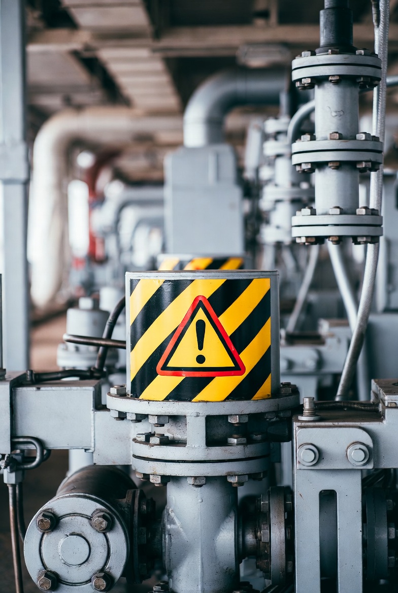 Female plant engineer standing inside an industrial facility highlighting hidden asset risks and overlooked equipment in manufacturing plants